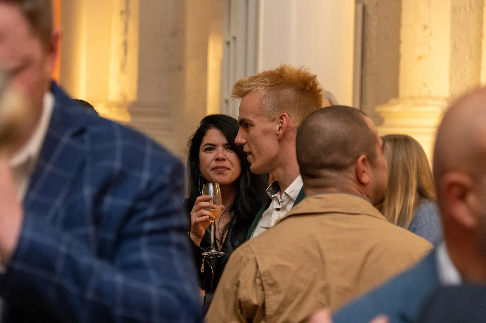Alex chatting with guests at an event