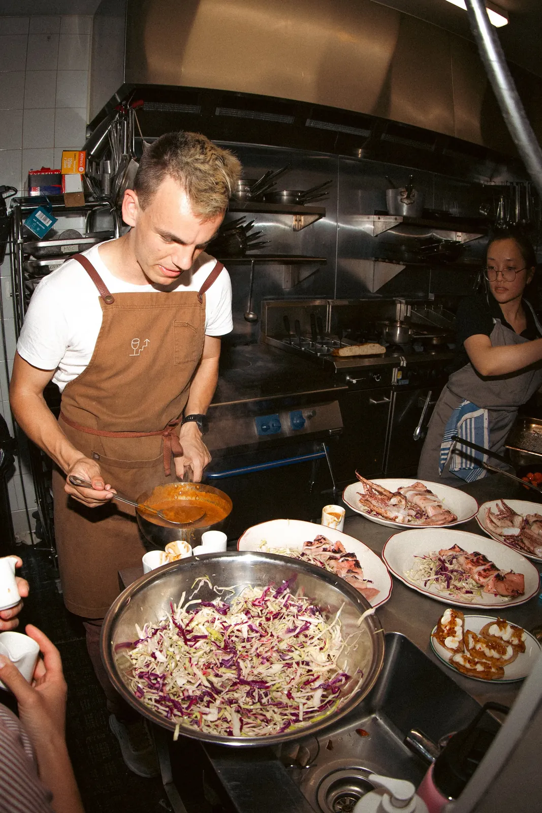 Alex plating a dish at The Melbourne Test Kitchen