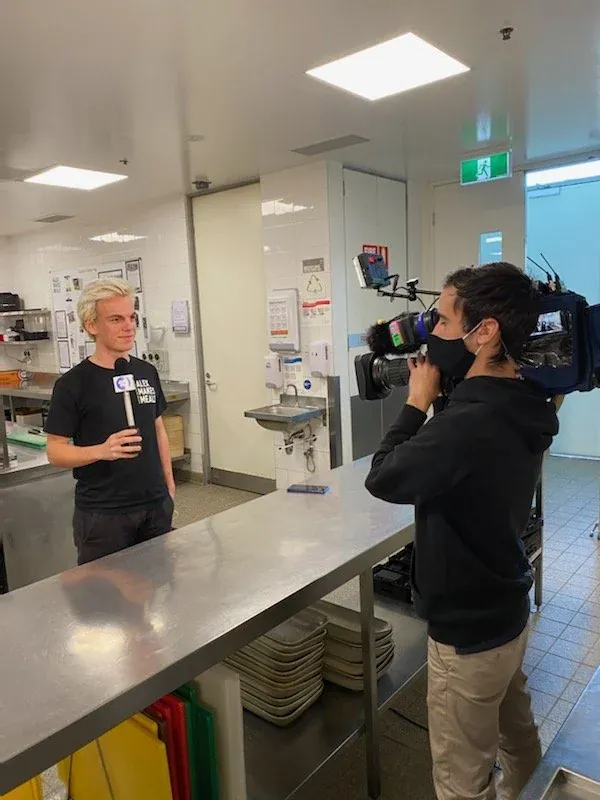 Alex being filmed for a TV interview in the kitchen