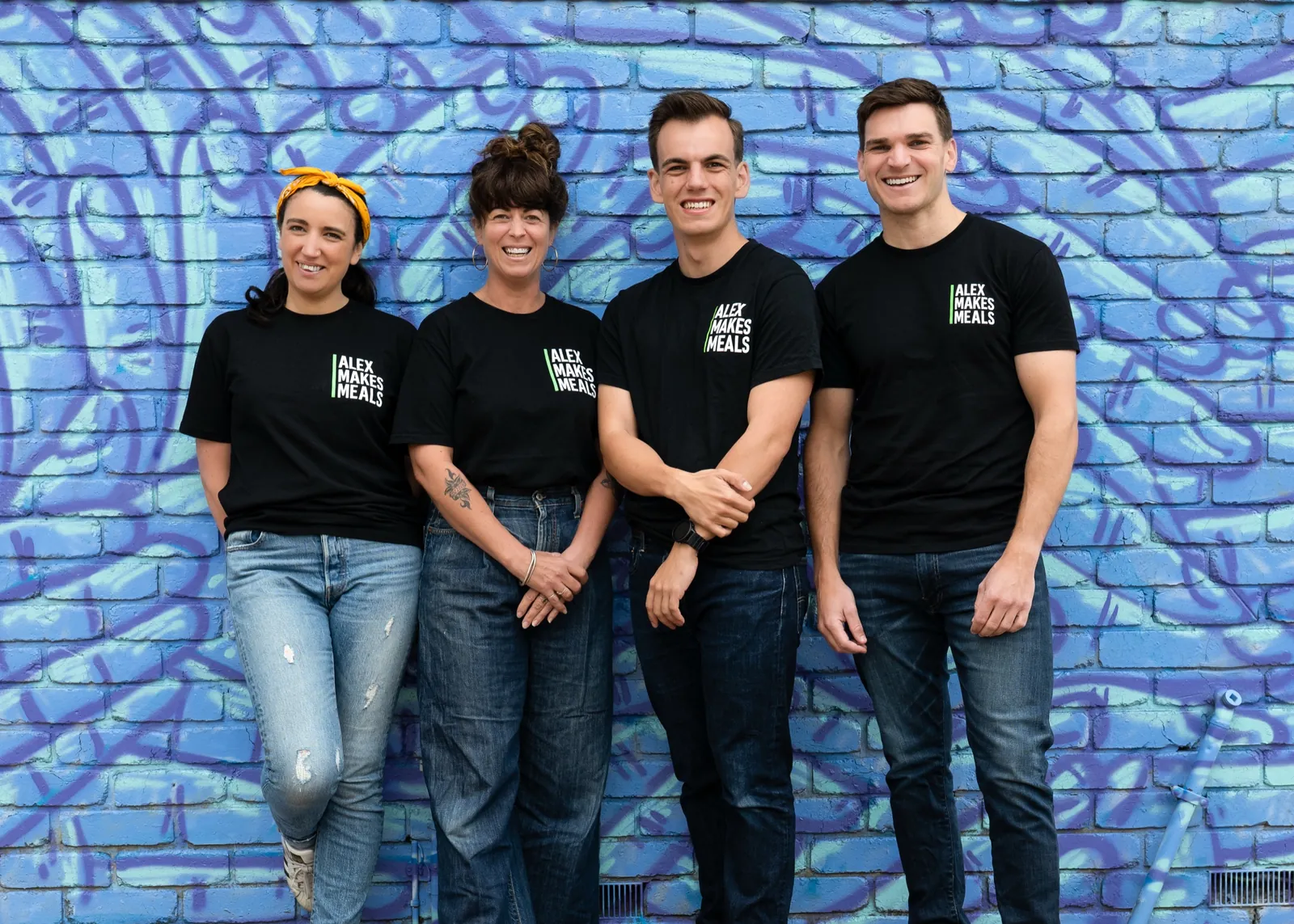 The Alex Makes Meals team in front of a mural