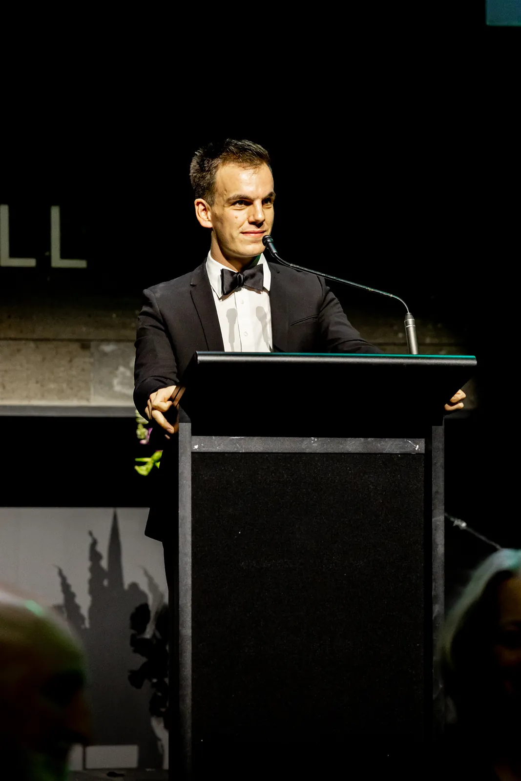 Alex at the podium at the 2026 Feast To Feed gala