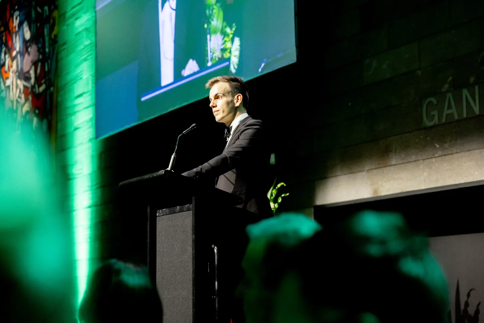 Alex at the podium at the 2026 Feast To Feed gala